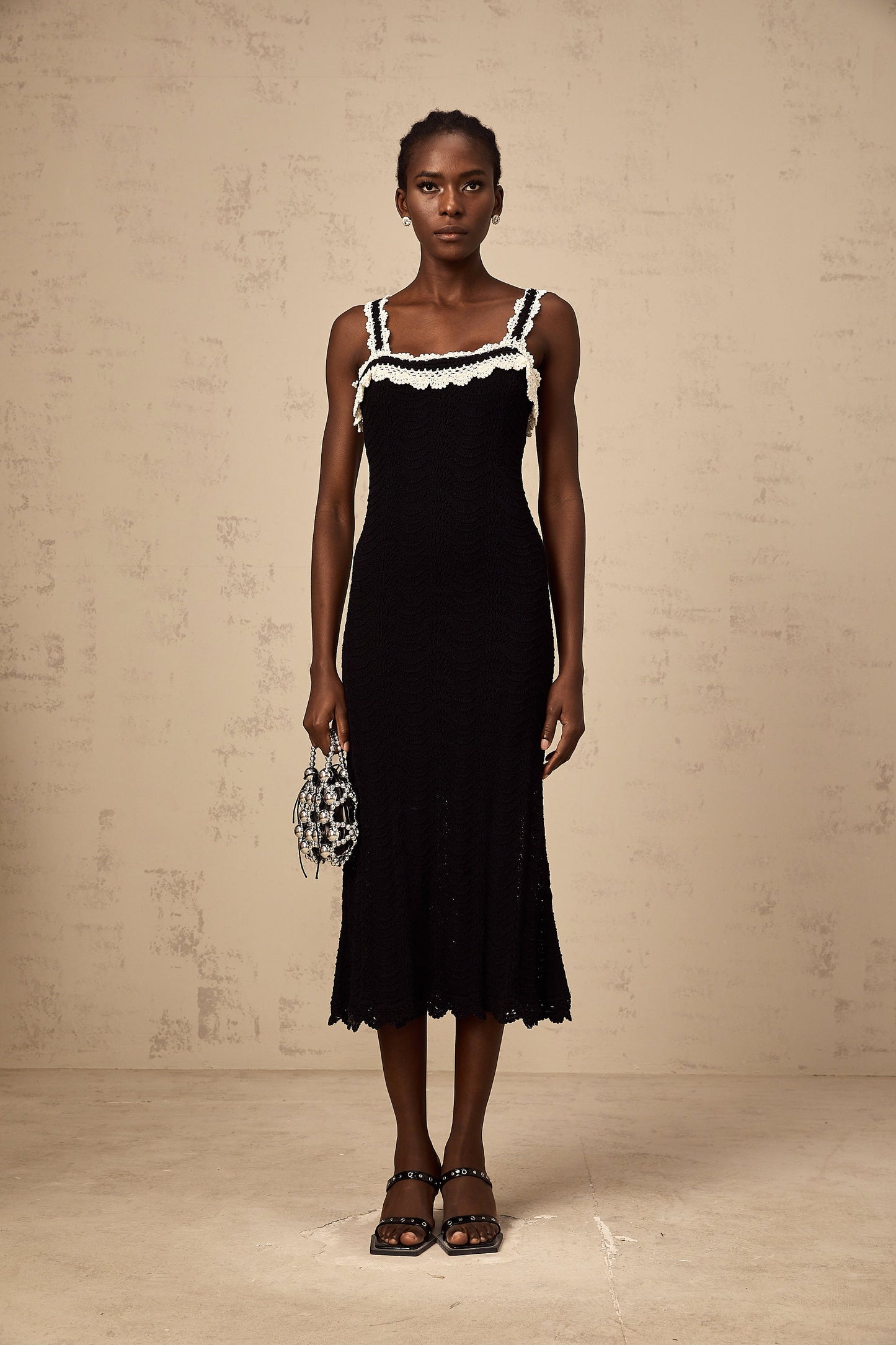 Noémie black sleeveless crochet-knit midi dress