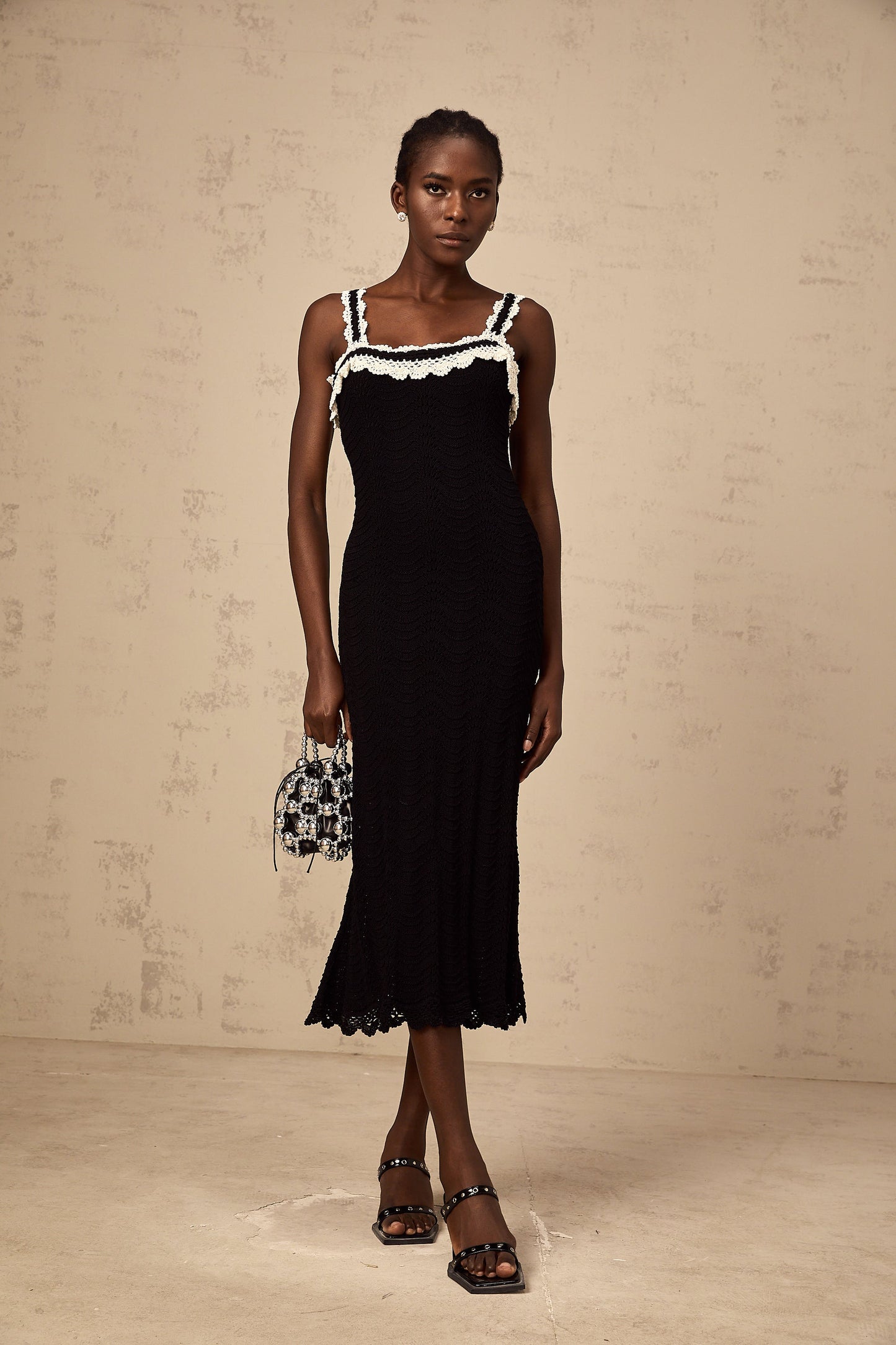 Noémie black sleeveless crochet-knit midi dress